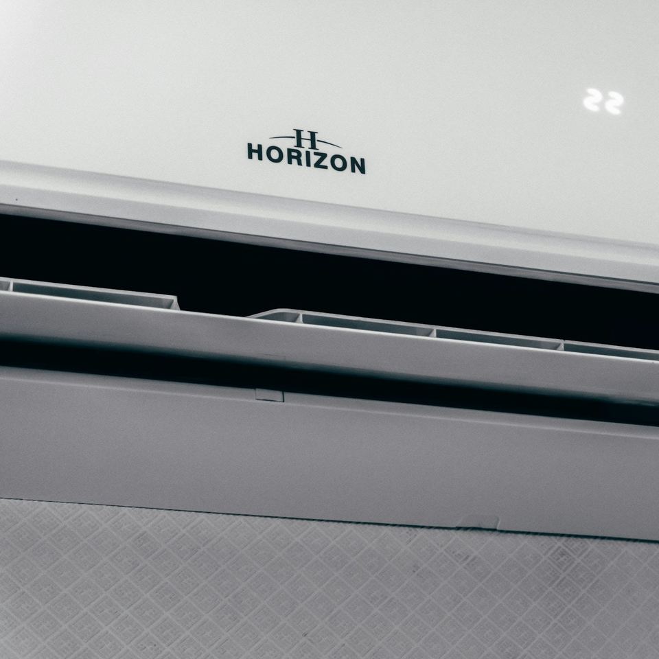 Close-up of an air conditioning unit with its louvre open, set to 22 degrees