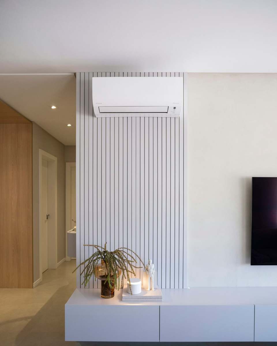 Wall-mounted air conditioning unit above a living room media wall