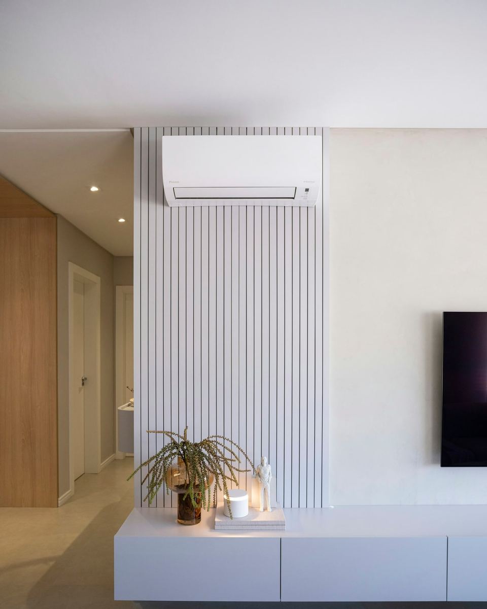 Wall-mounted air conditioning unit above a living room media wall